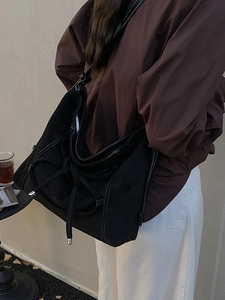 Large black frosted tote bag with white contrast stitching and drawstring detail