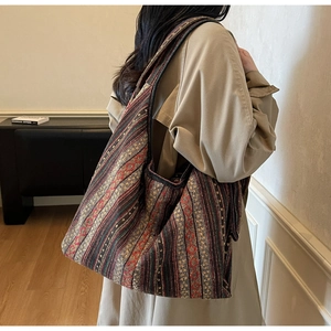 Close-up of bohemian ethnic pattern tote bag on model in casual trench coat