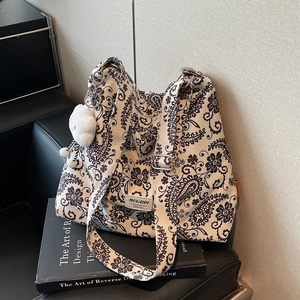 Vintage leopard print canvas tote bag with adjustable strap and fluffy white charm