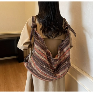 Detailed back view of a large ethnic style hobo bag with colorful woven geometric patterns