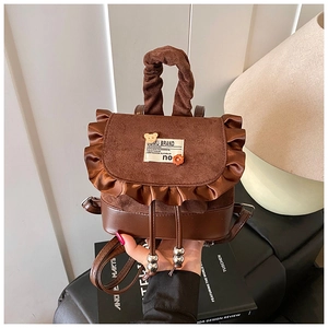 Detail of vintage brown mini backpack featuring leopard print, satin ruffle, and scrunchie handle