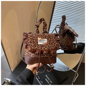 Detail of leopard print backpack with brown leather trim and ruffled edge decoration