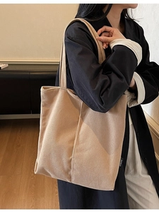 Large khaki corduroy tote bag for women showing a stylish minimalist shoulder carry look