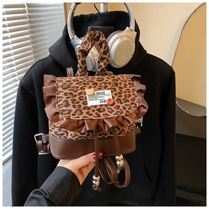 Detail of leopard print mini backpack with ruffled trim and stylish PU leather accents