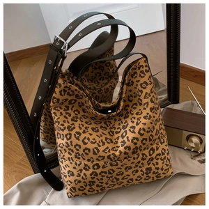 Detailed view of leopard print hobo bag with adjustable black strap and silver eyelets