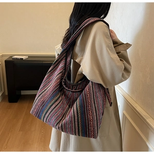 Detailed texture of bohemian ethnic woven tote bag with colorful geometric stripes