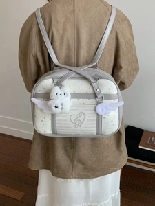 Grey and white star patterned backpack with angel wings and plush toy accessory