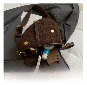 Detail view of the brown teddy plush saddle bag interior with daily essentials and gold hardware