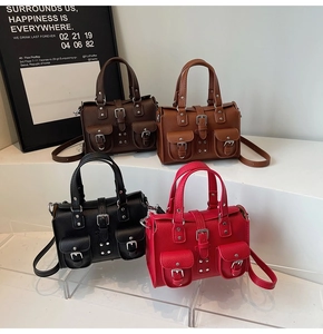 Detailed display of four textured lychee leather handbags in black, brown, and red colors