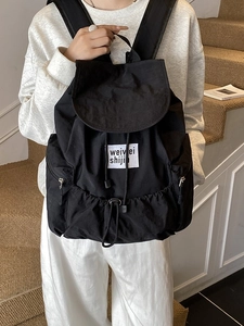 Lightweight black nylon drawstring backpack for students with flap cover and side zippers