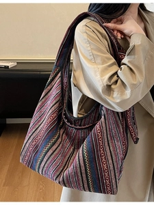 Ethnic striped hobo bag with wide shoulder strap shown as casual crossbody style