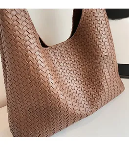 Nahaufnahme der dunkelbraunen geflochtenen Tragetasche mit weicher Textur und Lederdetails