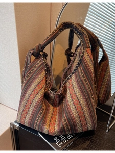 Ethnic style woven canvas tote bag with geometric stripe pattern in a modern room