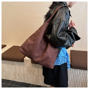 Close-up of brown suede oversized tote bag featuring a high-quality matte leather texture