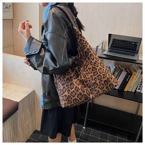 Close-up of leopard print tote bag with large capacity shown on person
