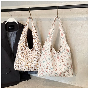 Detail view of quilted canvas tote bags featuring cute cartoon bear and bunny prints