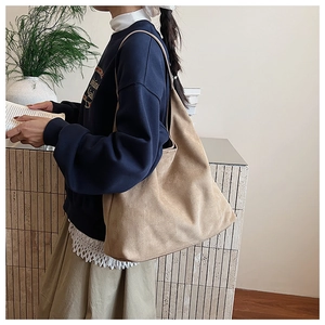 Detail of soft suede tote bag in camel tone, showing the premium matte texture and relaxed style