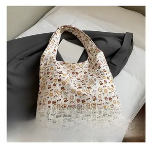 Detail shot of white tote bag featuring bubble textured fabric and cute cartoon bear prints