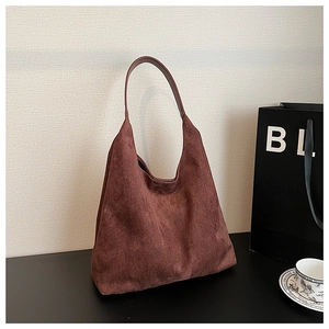 Macro detail of the wine red suede tote bag showing soft matte texture and Hobo design
