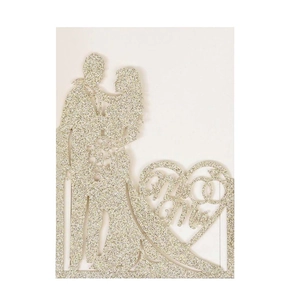 Close-up of Mr & Mrs heart-shaped glitter cake topper with bride and groom silhouette