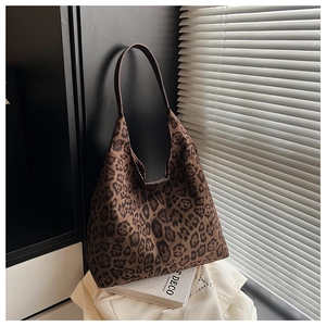 Detailed view of leopard print hobo tote bag in a stylish lifestyle setting with soft shadows