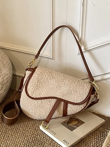Chic sherpa and brown leather saddle bag with gold D-ring hardware and dual straps