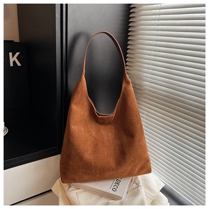 Detail of spacious dark brown suede shoulder tote with wide strap for daily commute