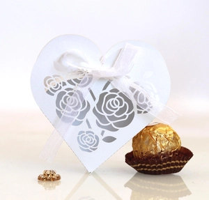 Elegant white laser-cut heart candy box with rose patterns and a sheer organza ribbon bow