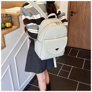 Chic beige faux leather backpack with quilted front pocket and adjustable shoulder straps