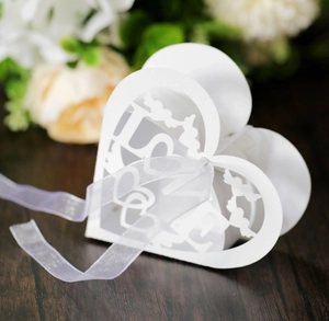 Detailed laser-cut white heart candy box with Love birds design and purple ribbon