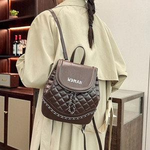 Quilted dark brown leather backpack with V-shaped metal chain and logo on the flap