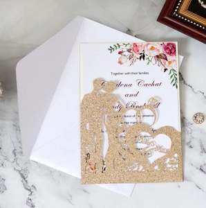 Macro detail of gold glitter laser-cut wedding invitation set with Mr & Mrs heart motif