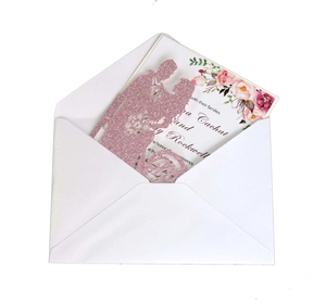 Detail of pink glitter laser-cut wedding invitation featuring bride and groom silhouette