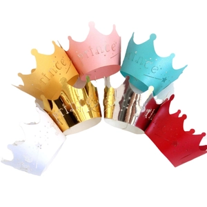 Golden and multicolored paper crown party hats with prince star patterns for celebrations