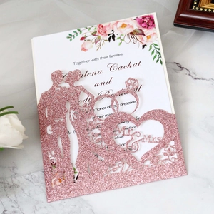 Detail of rose gold glitter laser-cut wedding invitation with Mr & Mrs silhouette design