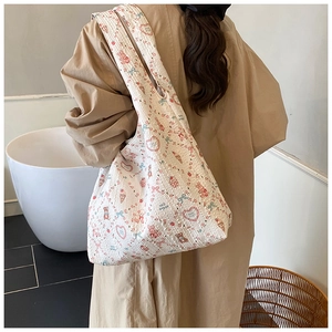 Detail of quilted cotton tote bag featuring cute cartoon bear and bunny patterns