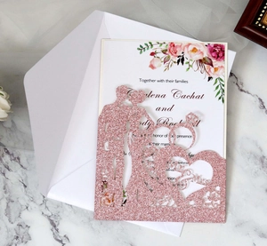 Close-up of glitter rose gold laser-cut wedding invitation with Mr & Mrs silhouette