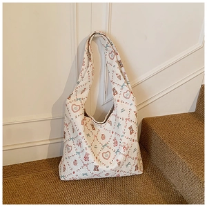 Detail of white quilted tote bag featuring cute cartoon bear and rabbit prints
