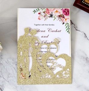 Detail of glitter gold laser-cut wedding invitation featuring Mr & Mrs on marble background
