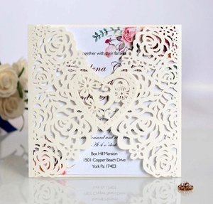 Close-up of laser-cut rose invitation card with floral insert and pearl finish cover