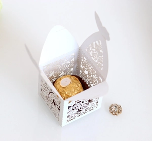 Elegant laser-cut white favor box with rose patterns and butterfly closure for weddings