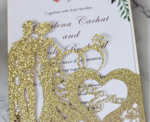 Detail of gold glitter wedding cake topper with Mr & Mrs text and laser cut heart frame