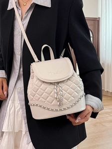 Elegant cream quilted backpack with silver chain detail for stylish women commuting