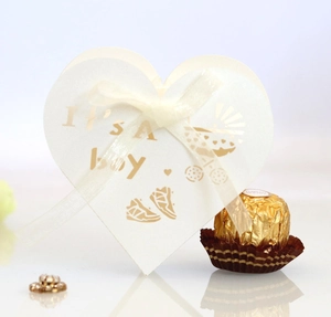 White heart-shaped baby shower gift box with gold foil It's a Boy text and white ribbon