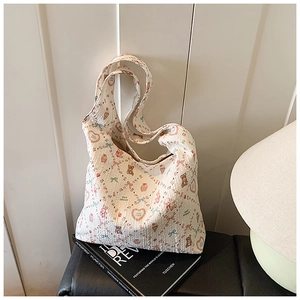 Close-up of quilted hobo bag featuring teddy bear prints and soft waffle texture