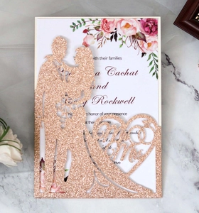 Detail of laser cut rose gold glitter wedding invitation with Mr & Mrs heart silhouette