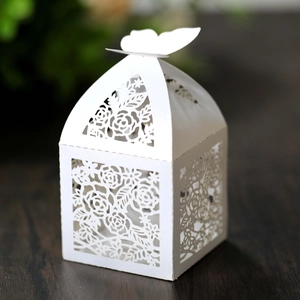 Detailed laser-cut rose patterns on white paper gift box with a butterfly closure