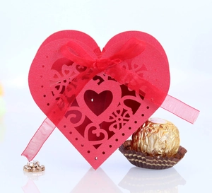 Laser-cut red heart gift box with intricate floral hollow patterns and silk ribbon
