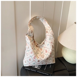 Detail view of large tote bag with cute cartoon bear print and bubbly textured fabric
