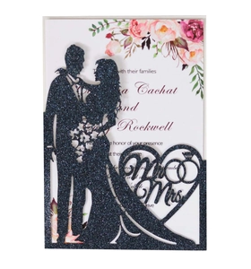 Detailed laser-cut wedding invitation featuring a navy glitter cover and floral inner card